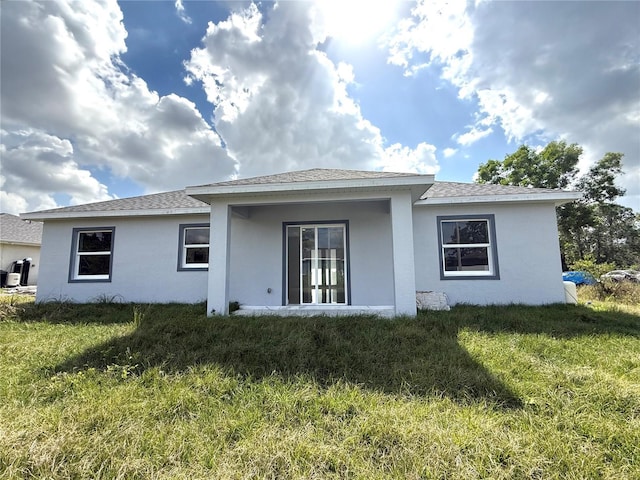 back of house featuring a yard