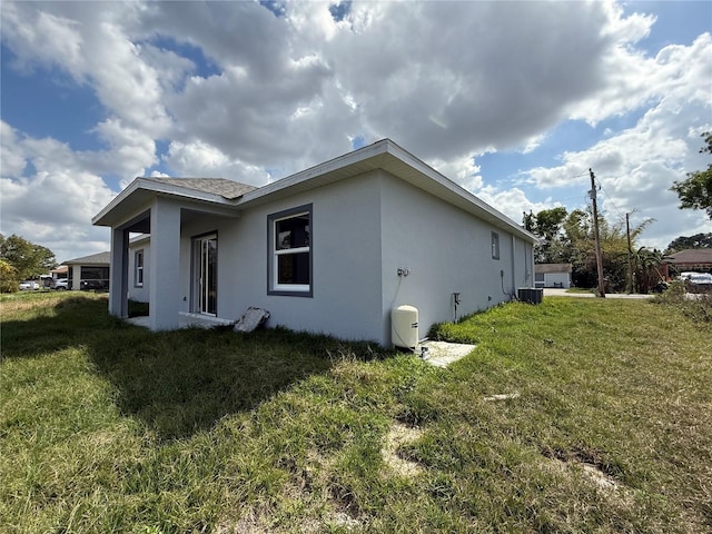 view of property exterior featuring a yard and central air condition unit