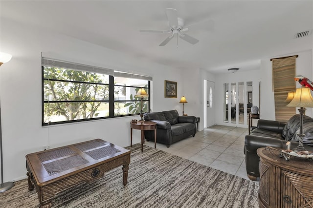 tiled living room with ceiling fan