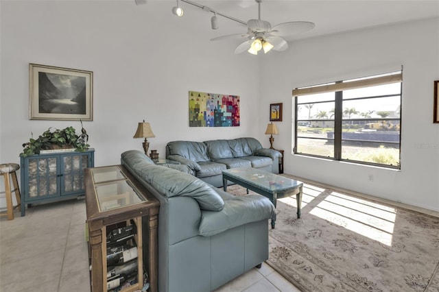 living room with light tile patterned floors, rail lighting, and ceiling fan