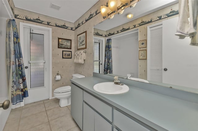 bathroom featuring tile patterned flooring, vanity, and toilet