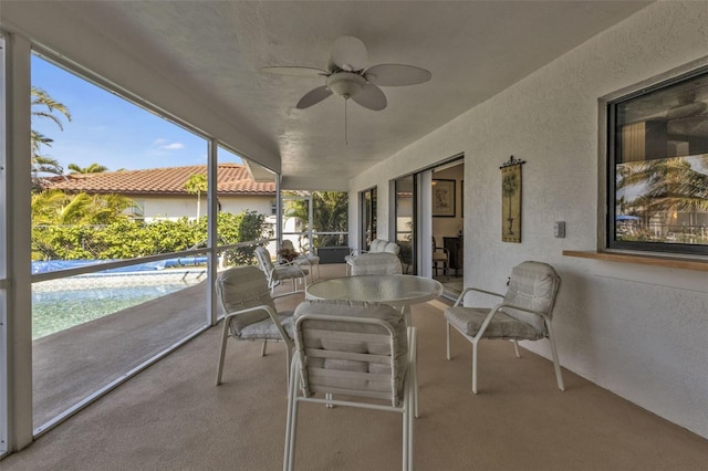 sunroom / solarium featuring ceiling fan