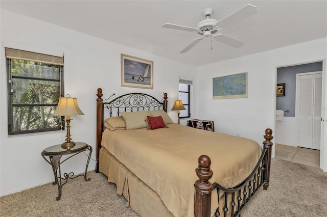 bedroom with ceiling fan and light colored carpet