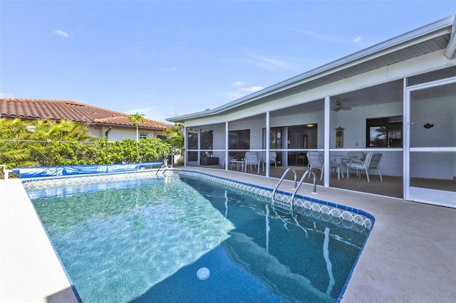 view of pool featuring ceiling fan, a patio area, and a sunroom