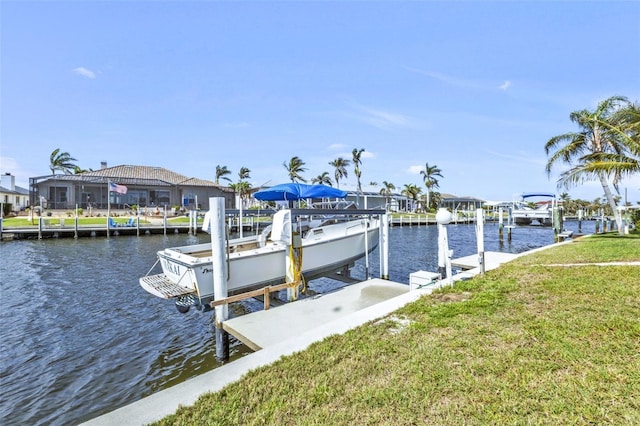 dock area with a water view and a yard