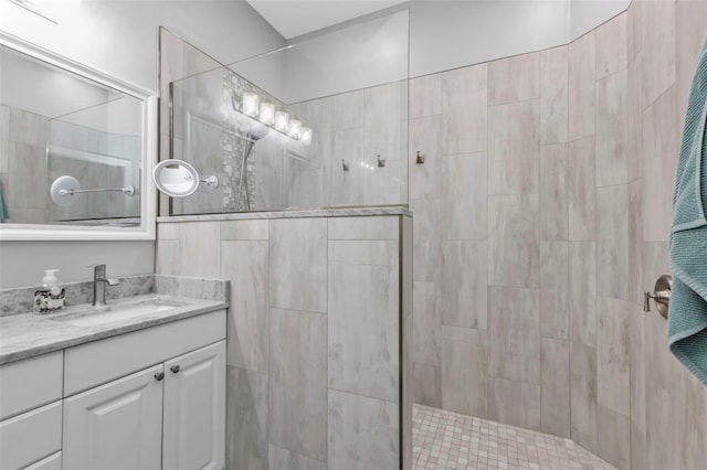 bathroom with vanity and a tile shower