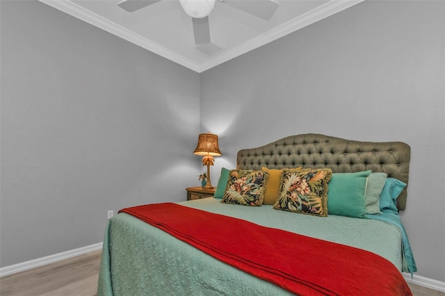 bedroom featuring hardwood / wood-style floors, ceiling fan, and ornamental molding