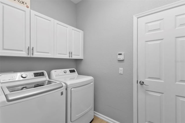 laundry room featuring cabinets and independent washer and dryer