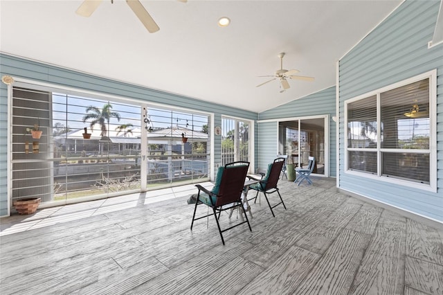 unfurnished sunroom featuring lofted ceiling and ceiling fan