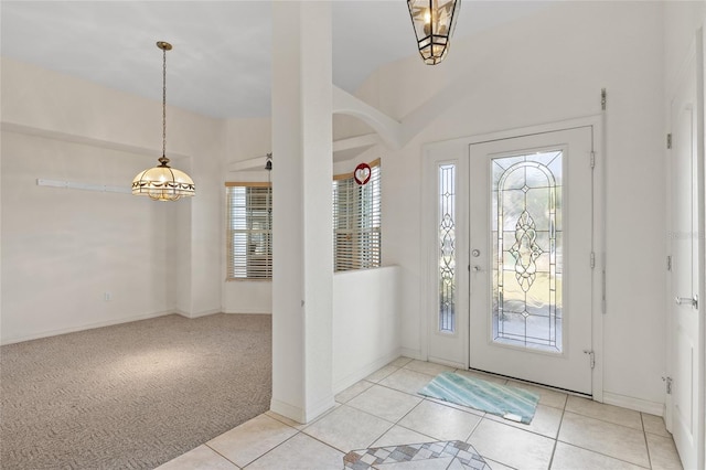 carpeted foyer entrance with lofted ceiling