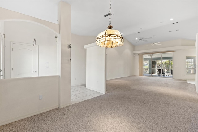 empty room featuring ceiling fan, lofted ceiling, and light carpet