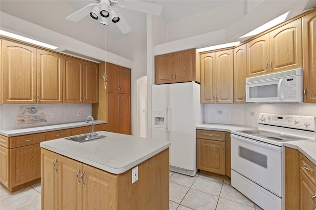 kitchen with light tile patterned flooring, sink, tasteful backsplash, a center island with sink, and white appliances