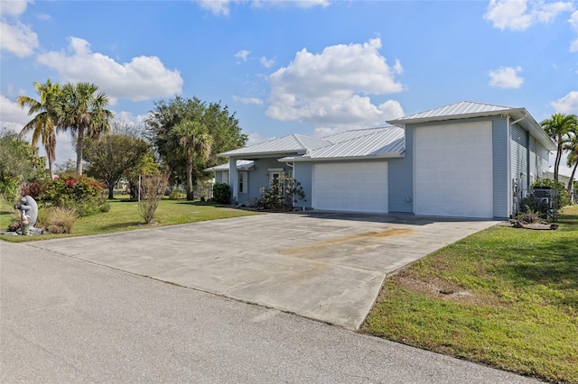 single story home featuring a garage and a front lawn