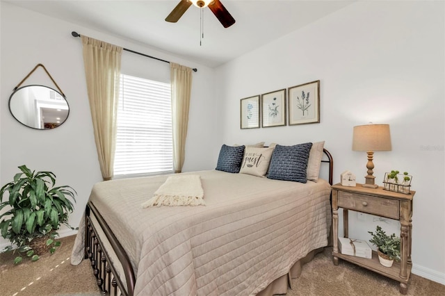 bedroom with a ceiling fan and carpet