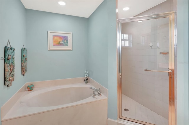 bathroom featuring shower with separate bathtub