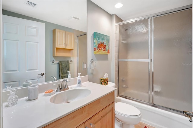 full bathroom with vanity, toilet, and combined bath / shower with glass door