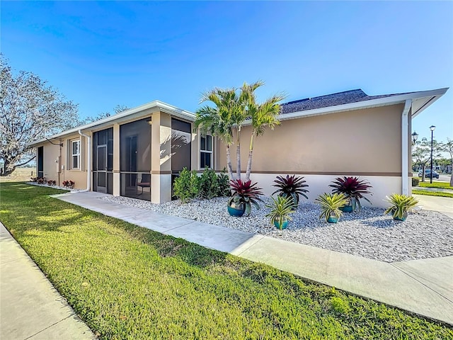 8858 Tuscany Isles Dr, Punta Gorda, FL 33950 - view of front of property with a sunroom and a front yard