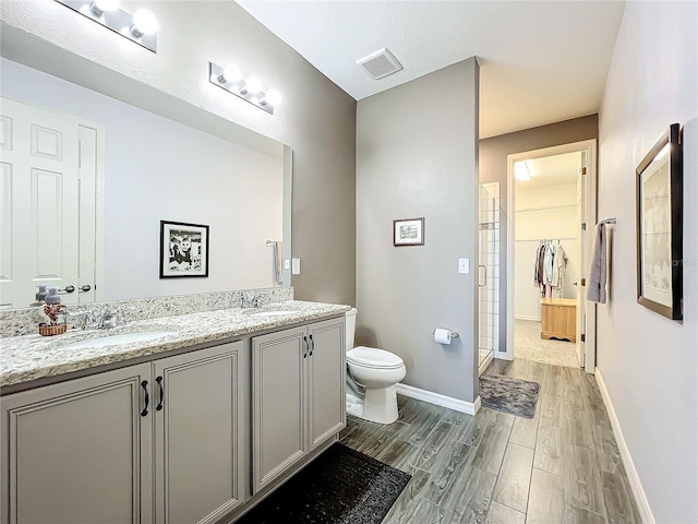 8858 Tuscany Isles Dr, Punta Gorda, FL 33950 - bathroom featuring walk in shower, wood-type flooring, toilet, and vanity