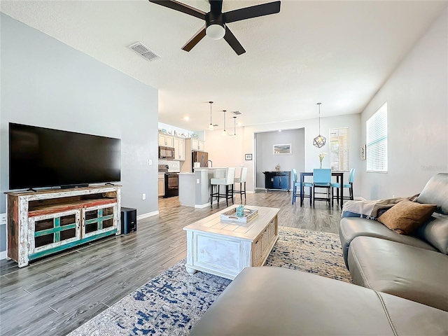 8858 Tuscany Isles Dr, Punta Gorda, FL 33950 - living room featuring wood-type flooring and ceiling fan