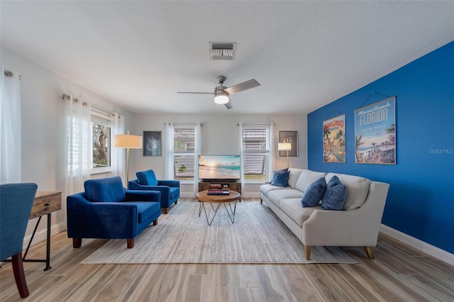 living room featuring ceiling fan and hardwood / wood-style floors