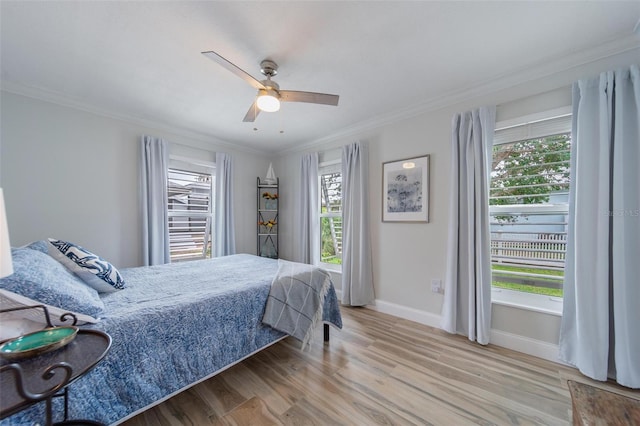 bedroom featuring ornamental molding, ceiling fan, and wood-type flooring