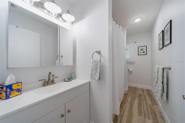 bathroom with vanity and wood-type flooring