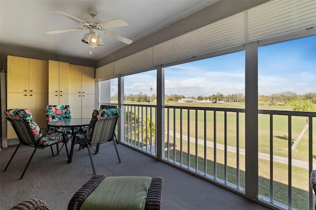 sunroom / solarium featuring ceiling fan