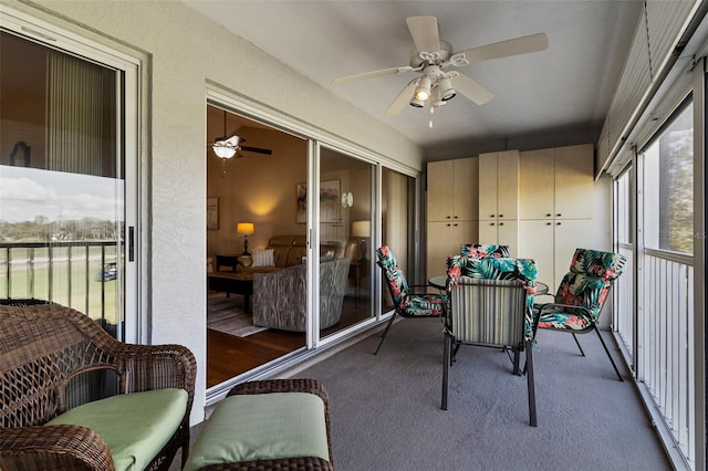 sunroom / solarium featuring ceiling fan