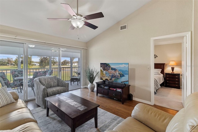 living room with vaulted ceiling, wood-type flooring, and ceiling fan