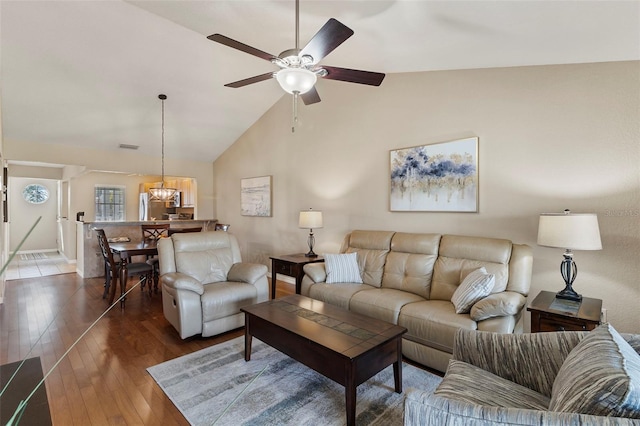 living room featuring ceiling fan, dark hardwood / wood-style flooring, and high vaulted ceiling