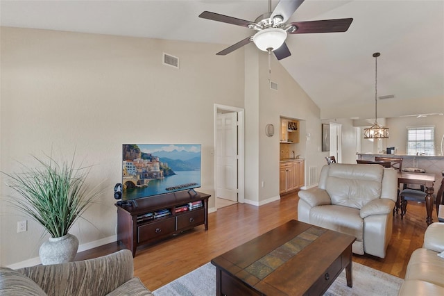 living room featuring high vaulted ceiling, hardwood / wood-style floors, and ceiling fan