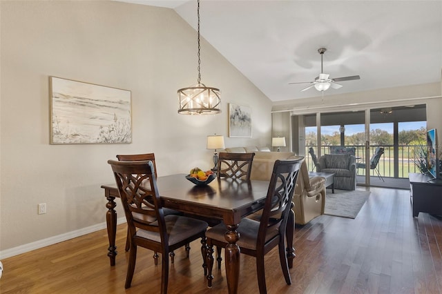 dining room featuring high vaulted ceiling, dark wood-type flooring, and ceiling fan