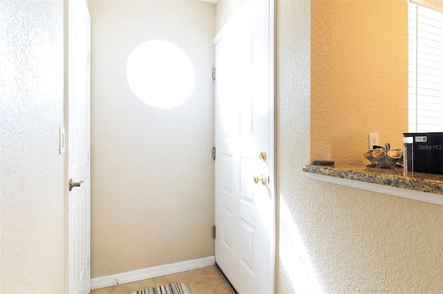 entryway featuring light tile patterned floors