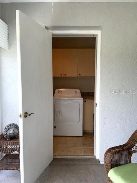 laundry area with cabinets, washer / clothes dryer, and light carpet