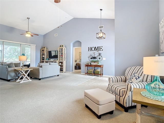 carpeted living room featuring high vaulted ceiling and ceiling fan