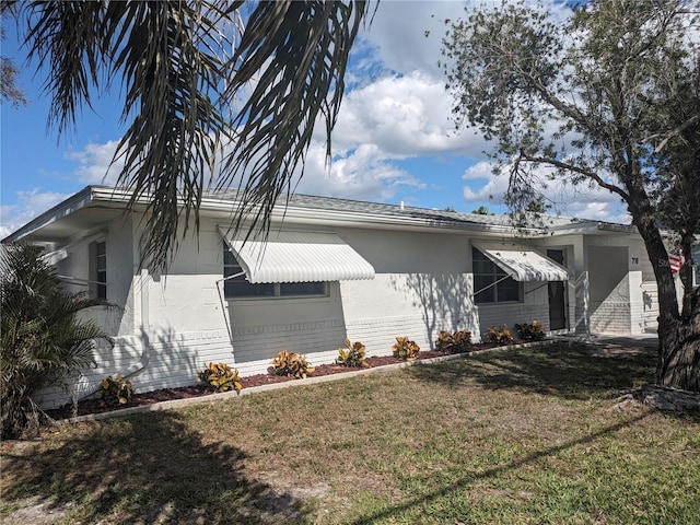 710 Aqui Esta Dr, Punta Gorda, FL 33950 - view of property exterior featuring a lawn