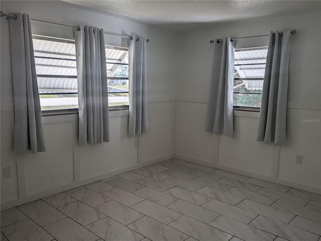 710 Aqui Esta Dr, Punta Gorda, FL 33950 - unfurnished room featuring a textured ceiling and a healthy amount of sunlight