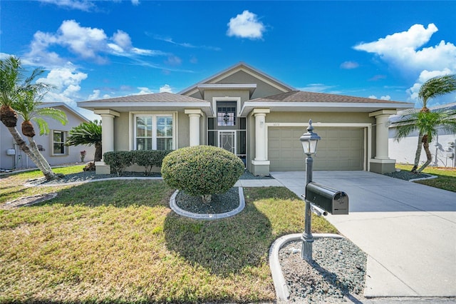 view of front of house with a garage and a front yard