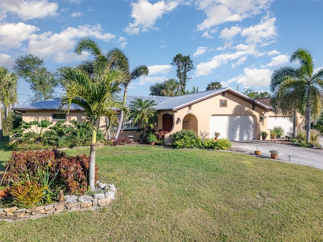 single story home featuring a garage and a front yard