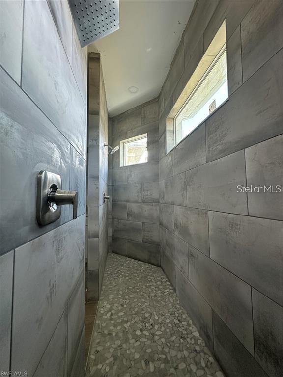 bathroom with a tile shower