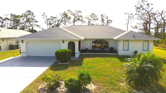 single story home featuring cooling unit, a garage, and a front yard