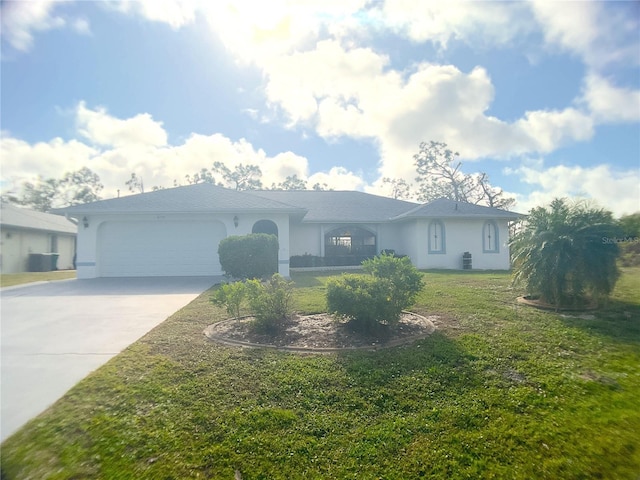 ranch-style home with a garage and a front lawn