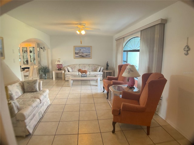 living room featuring light tile patterned floors and ceiling fan