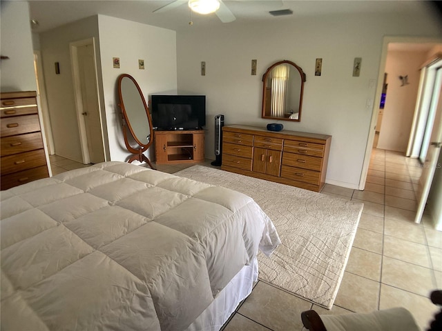 bedroom with ceiling fan and light tile patterned floors