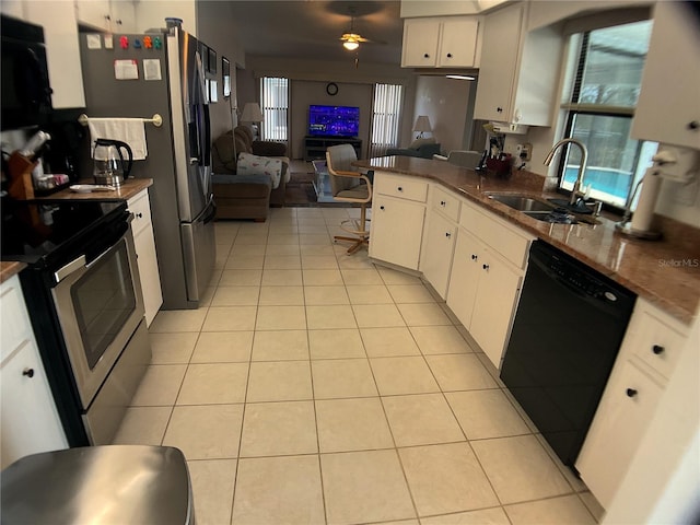 kitchen featuring sink, light tile patterned floors, white cabinetry, black appliances, and kitchen peninsula