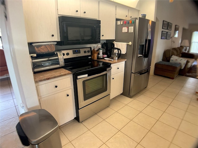 kitchen featuring stainless steel appliances, white cabinets, and light tile patterned flooring