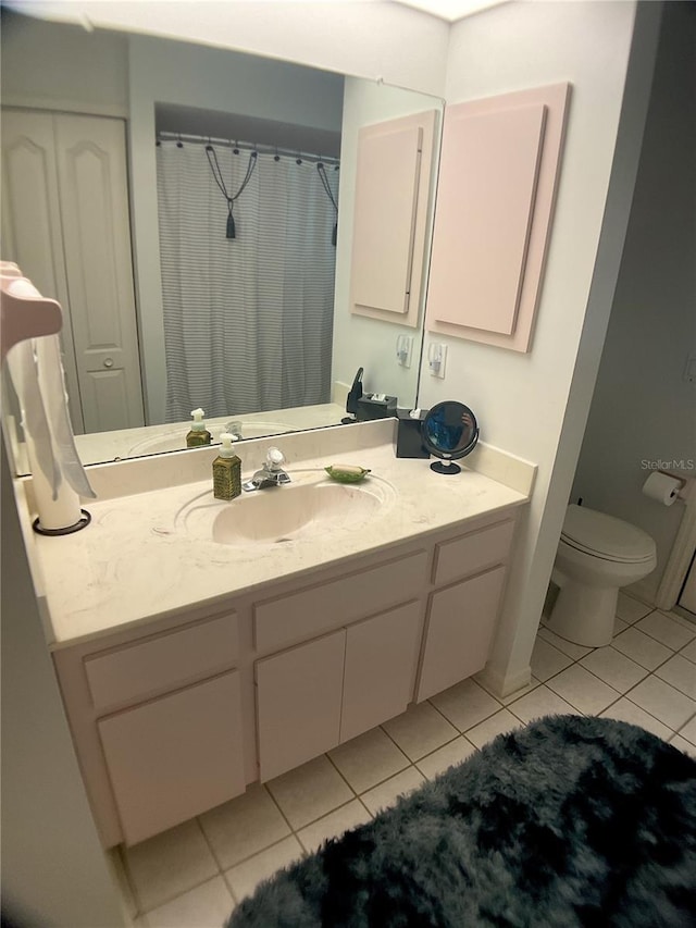 bathroom featuring vanity, toilet, and tile patterned flooring