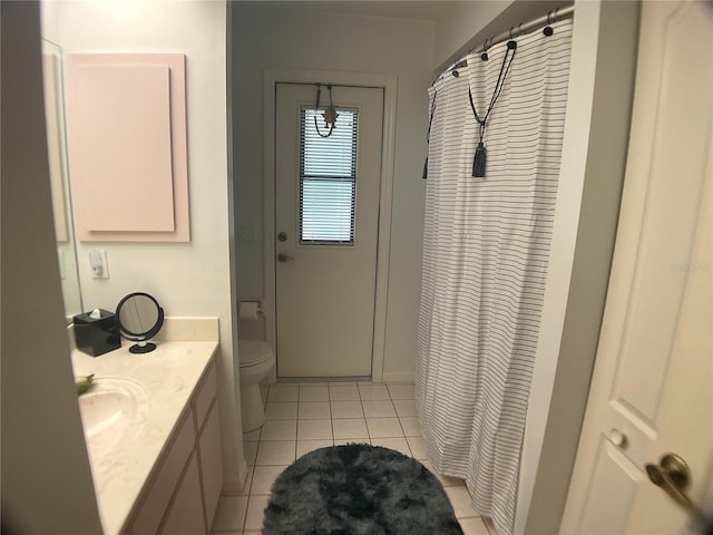 bathroom with tile patterned flooring, vanity, walk in shower, and toilet