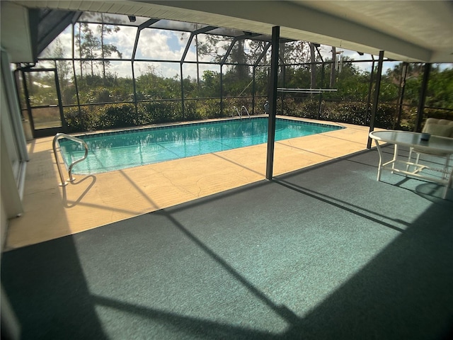 view of swimming pool featuring a patio and glass enclosure