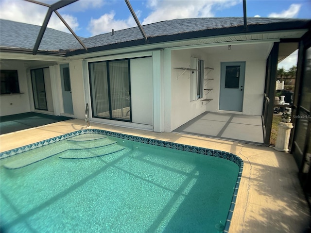 view of swimming pool with a lanai and a patio area